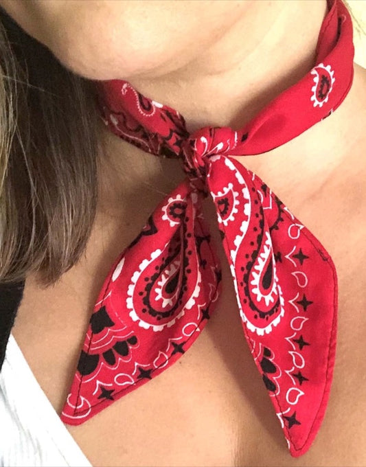 This is a photo of a woman wearing a red bandana neck scarf tie.